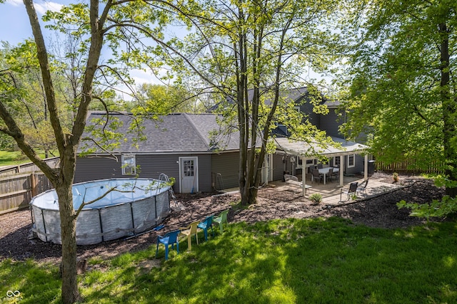 1052 Barley Cir, Carmel, IN 46032 - rear view of property featuring an outdoor pool, a shingled roof, and a patio area