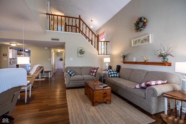 1052 Barley Cir, Carmel, IN 46032 - living area featuring high vaulted ceiling, dark wood-type flooring, and stairs