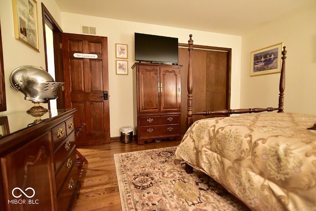 6412 Fall Creek Rd, Indianapolis, IN 46220 - bedroom featuring dark wood-style flooring and a closet