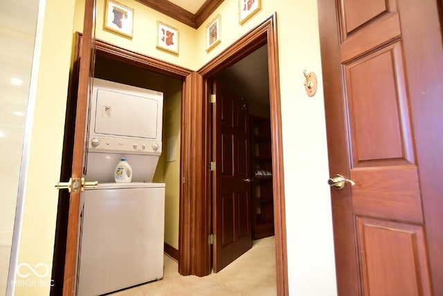 6412 Fall Creek Rd, Indianapolis, IN 46220 - washroom featuring estacked washer and dryer and light tile patterned flooring