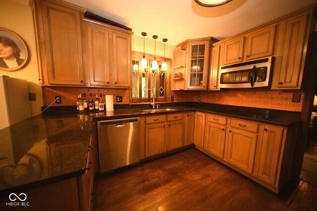6412 Fall Creek Rd, Indianapolis, IN 46220 - kitchen featuring stainless steel appliances, dark wood-type flooring, pendant lighting, a sink, and tasteful backsplash