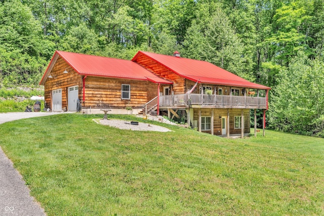 2780 W Grizzly Trl, Martinsville, IN 46151 - view of front of home with a front lawn, a wooden deck, driveway, metal roof, and a forest view