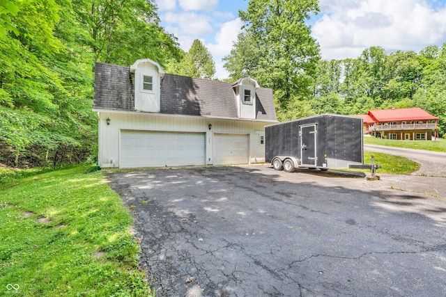 2780 W Grizzly Trl, Martinsville, IN 46151 - view of property exterior with an outdoor structure, asphalt driveway, and a shingled roof