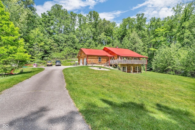 2780 W Grizzly Trl, Martinsville, IN 46151 - log cabin featuring a garage, a front lawn, a deck, driveway, and a forest view