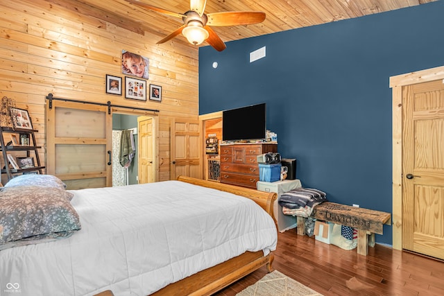 2780 W Grizzly Trl, Martinsville, IN 46151 - bedroom featuring high vaulted ceiling, wood walls, a barn door, wood finished floors, and wooden ceiling