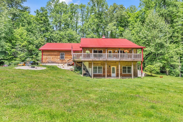 2780 W Grizzly Trl, Martinsville, IN 46151 - back of house featuring a deck, a lawn, metal roof, a chimney, and a fire pit
