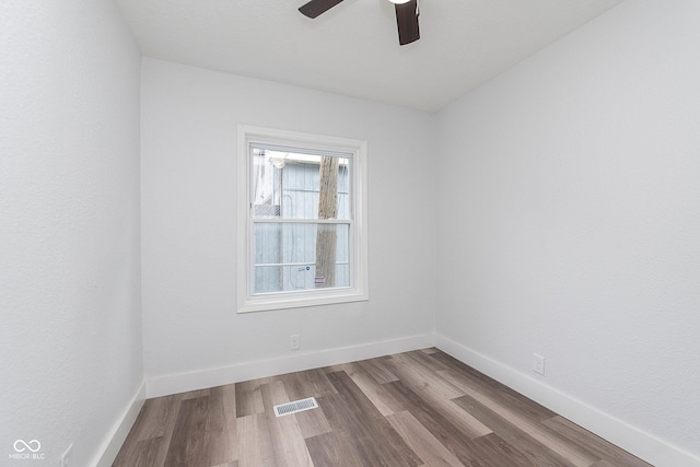 2531 E Brookside Ave, Indianapolis, IN 46218 - spare room featuring a ceiling fan, wood finished floors, and baseboards