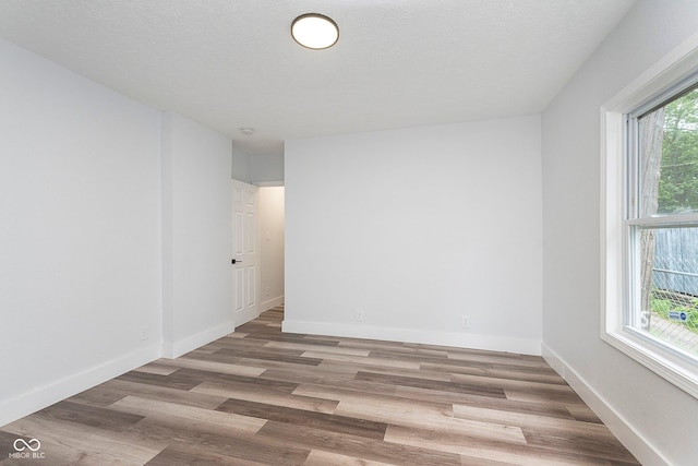 2531 E Brookside Ave, Indianapolis, IN 46218 - spare room with wood finished floors and baseboards
