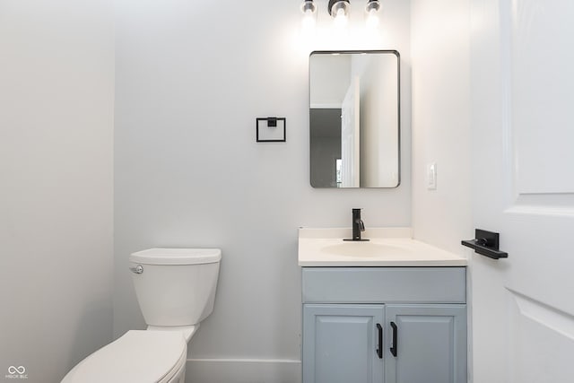2531 E Brookside Ave, Indianapolis, IN 46218 - half bath featuring toilet, vanity, and baseboards