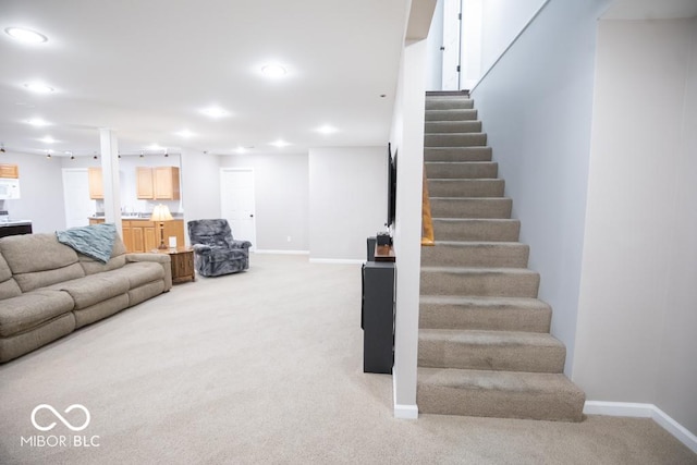 495 Persimmon Dr, North Vernon, IN 47265 - living room featuring light carpet, stairway, baseboards, and recessed lighting