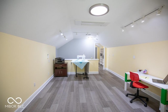 495 Persimmon Dr, North Vernon, IN 47265 - office featuring rail lighting, vaulted ceiling, wood finished floors, and baseboards