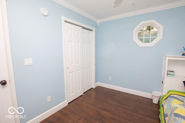 495 Persimmon Dr, North Vernon, IN 47265 - unfurnished bedroom featuring dark wood finished floors, baseboards, crown molding, and a closet
