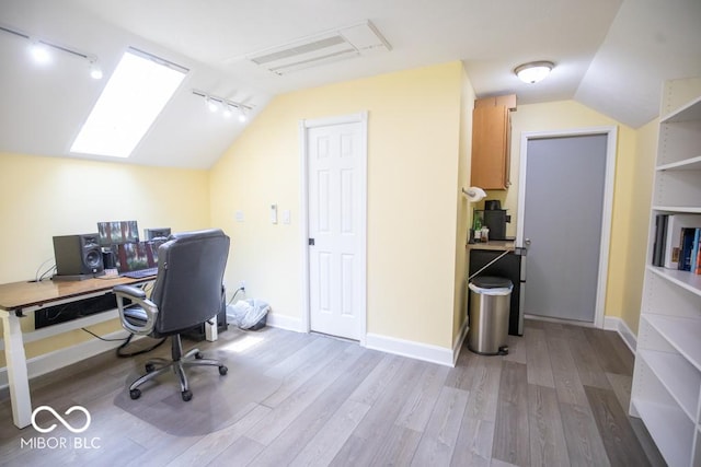 495 Persimmon Dr, North Vernon, IN 47265 - office featuring track lighting, lofted ceiling, wood finished floors, and baseboards