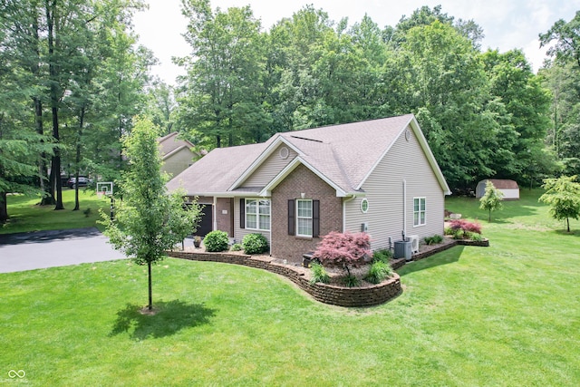 495 Persimmon Dr, North Vernon, IN 47265 - ranch-style home with central AC, brick siding, a front yard, and a shingled roof