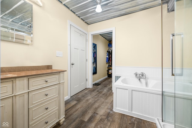 5730 S 50 W, Trafalgar, IN 46181 - bathroom featuring a bath, vanity, wood finished floors, and a walk in closet