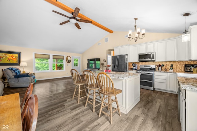 5730 S 50 W, Trafalgar, IN 46181 - kitchen featuring appliances with stainless steel finishes, open floor plan, dark wood-style flooring, beam ceiling, and a kitchen island