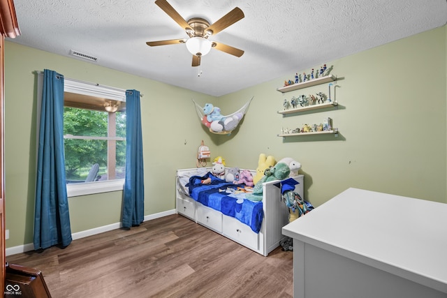 5730 S 50 W, Trafalgar, IN 46181 - bedroom featuring wood finished floors, a textured ceiling, ceiling fan, and baseboards