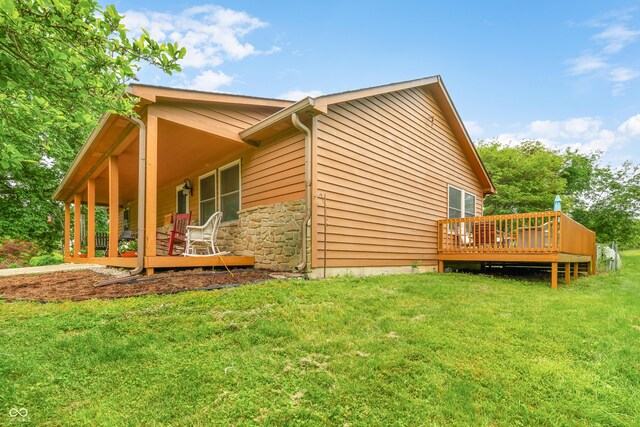 5730 S 50 W, Trafalgar, IN 46181 - view of property exterior with a yard, a deck, and stone siding