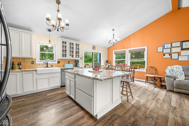 5730 S 50 W, Trafalgar, IN 46181 - kitchen featuring a chandelier, lofted ceiling, dark wood finished floors, a kitchen island, and healthy amount of natural light
