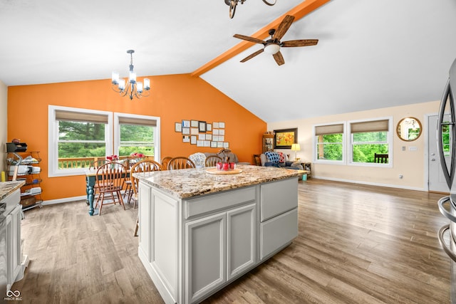 5730 S 50 W, Trafalgar, IN 46181 - kitchen featuring light wood-style floors, ceiling fan, open floor plan, a chandelier, and a kitchen island