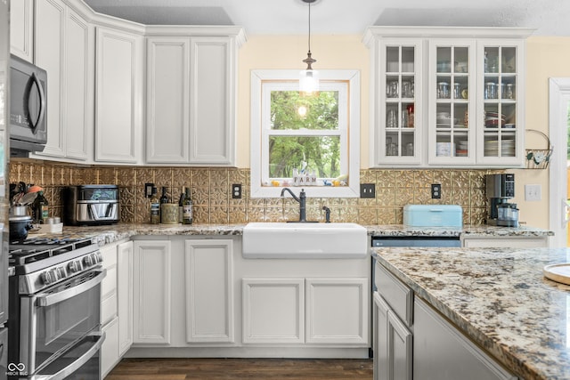 5730 S 50 W, Trafalgar, IN 46181 - kitchen with a sink, stainless steel appliances, glass insert cabinets, white cabinetry, and hanging light fixtures