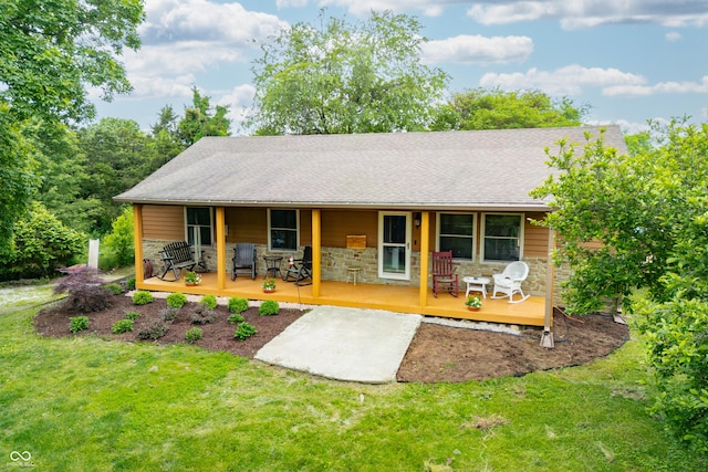 5730 S 50 W, Trafalgar, IN 46181 - view of front of house featuring covered porch, a front lawn, stone siding, and a shingled roof
