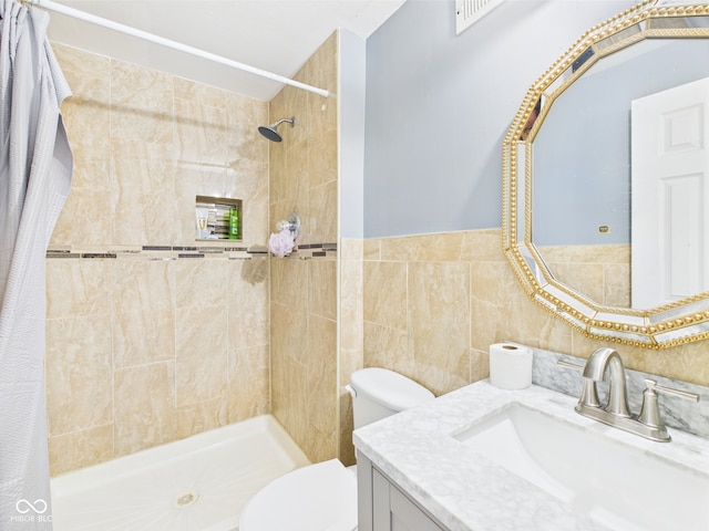 3223 Keystone Lakes Way, Indianapolis, IN 46237 - bathroom featuring vanity, toilet, a tile shower, and tile walls