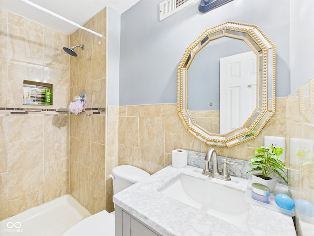 3223 Keystone Lakes Way, Indianapolis, IN 46237 - bathroom featuring tile walls, vanity, toilet, and tiled shower