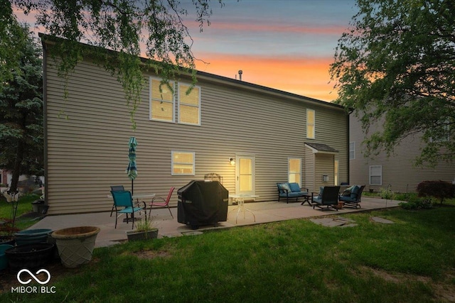 12624 Majestic Way, Fishers, IN 46037 - back of property at dusk with a patio, a lawn, and an outdoor living space