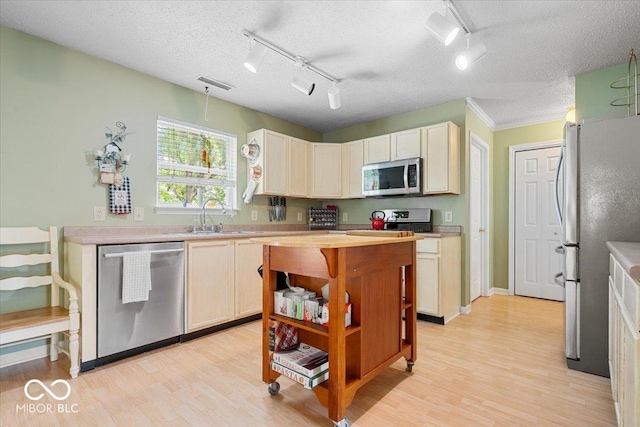 12624 Majestic Way, Fishers, IN 46037 - kitchen featuring appliances with stainless steel finishes, a sink, track lighting, light wood-style flooring, and open shelves