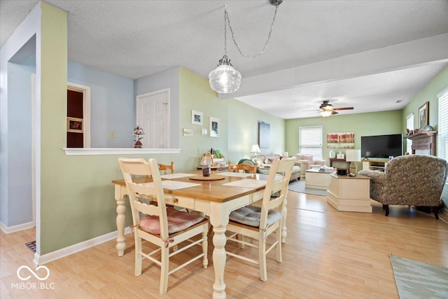 12624 Majestic Way, Fishers, IN 46037 - dining area with light wood-type flooring, a ceiling fan, a textured ceiling, and baseboards