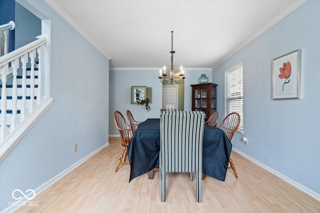 12624 Majestic Way, Fishers, IN 46037 - dining room featuring a chandelier, light wood-style floors, crown molding, and baseboards