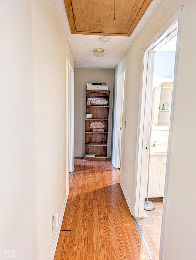 2612 E Michigantown Rd, Frankfort, IN 46041 - corridor featuring light wood finished floors, a sink, and baseboards