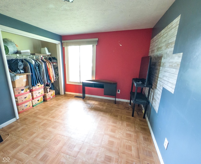 2612 E Michigantown Rd, Frankfort, IN 46041 - bedroom featuring baseboards, a closet, and a textured ceiling