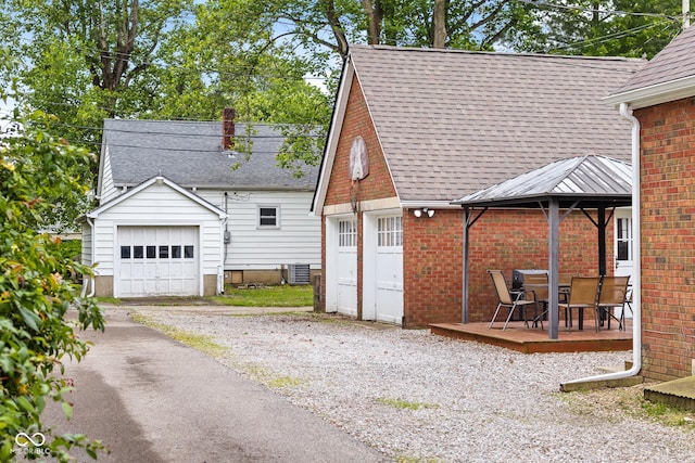 2645 Washington St, Columbus, IN 47201 - back of property with an outdoor structure, central AC unit, brick siding, and a gazebo