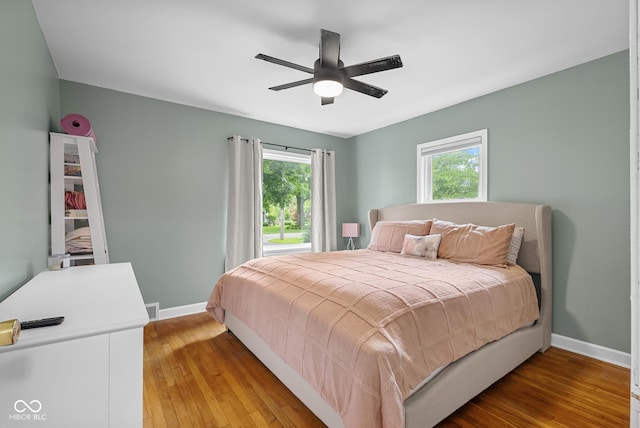 2645 Washington St, Columbus, IN 47201 - bedroom featuring baseboards, multiple windows, and light wood-style floors