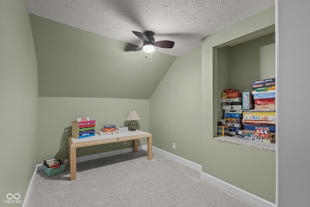 2645 Washington St, Columbus, IN 47201 - recreation room with vaulted ceiling, a ceiling fan, carpet flooring, baseboards, and a textured ceiling