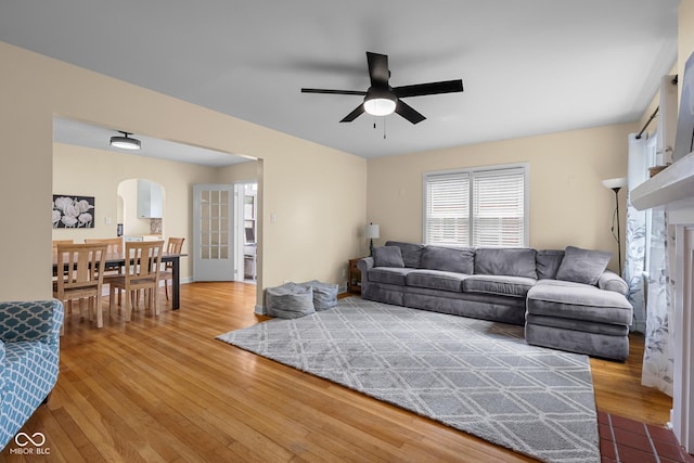 2645 Washington St, Columbus, IN 47201 - living room featuring arched walkways, hardwood / wood-style floors, and a ceiling fan