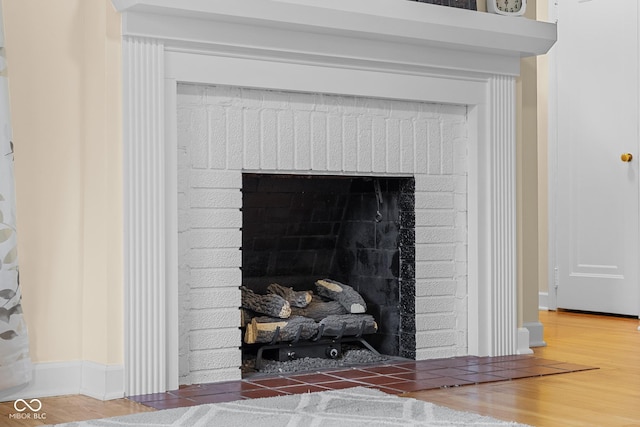 2645 Washington St, Columbus, IN 47201 - detailed view of a fireplace, wood finished floors, and baseboards
