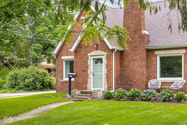 2645 Washington St, Columbus, IN 47201 - english style home with a front yard, brick siding, and a chimney