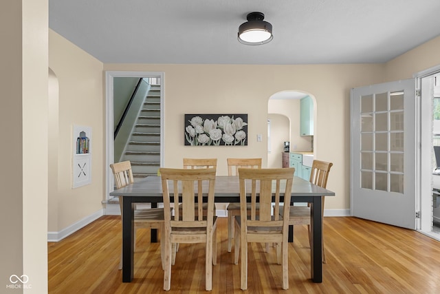 2645 Washington St, Columbus, IN 47201 - dining area featuring arched walkways, light wood-style floors, and baseboards