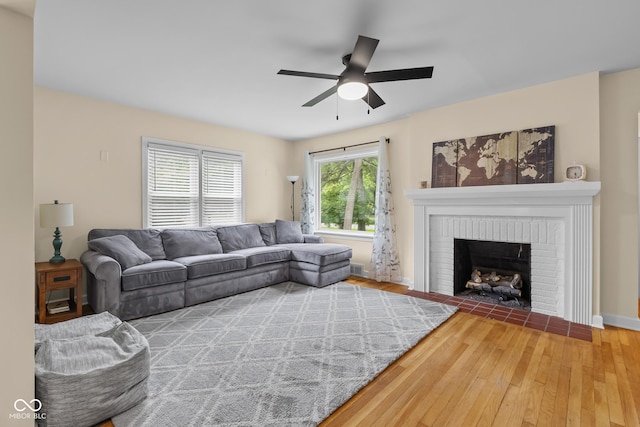 2645 Washington St, Columbus, IN 47201 - living area with wood finished floors, a ceiling fan, a fireplace, and baseboards