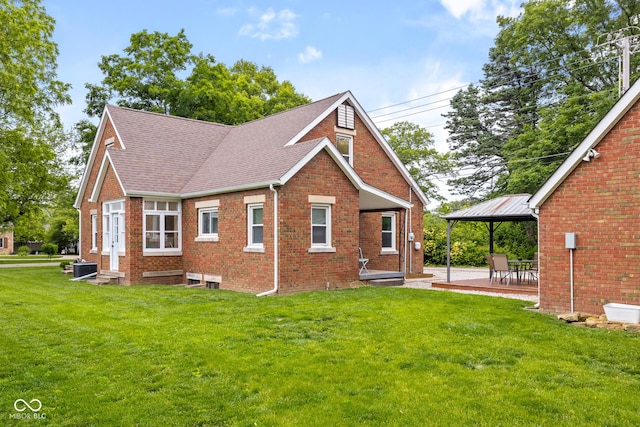 2645 Washington St, Columbus, IN 47201 - view of side of home featuring brick siding, a gazebo, a yard, roof with shingles, and a patio