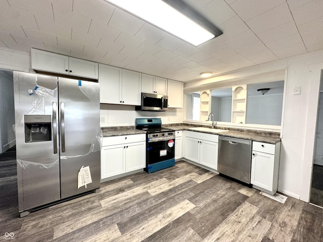 106 S Hancock St, Waynetown, IN 47990 - kitchen with appliances with stainless steel finishes, a sink, dark wood finished floors, and white cabinetry