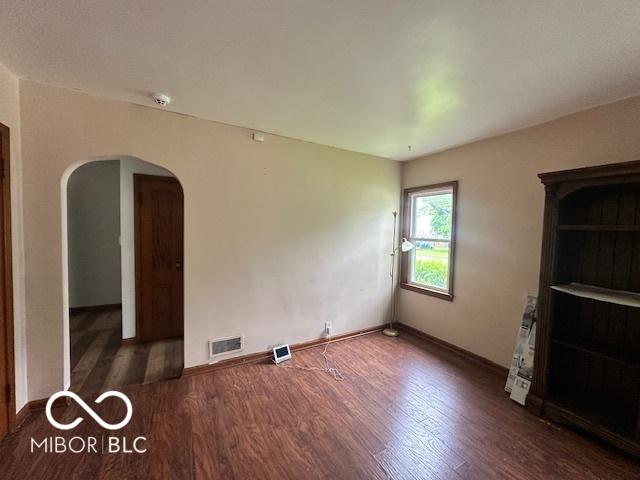 5147 E 16th St, Indianapolis, IN 46218 - unfurnished room featuring wood finished floors, arched walkways, baseboards, and a smoke detector