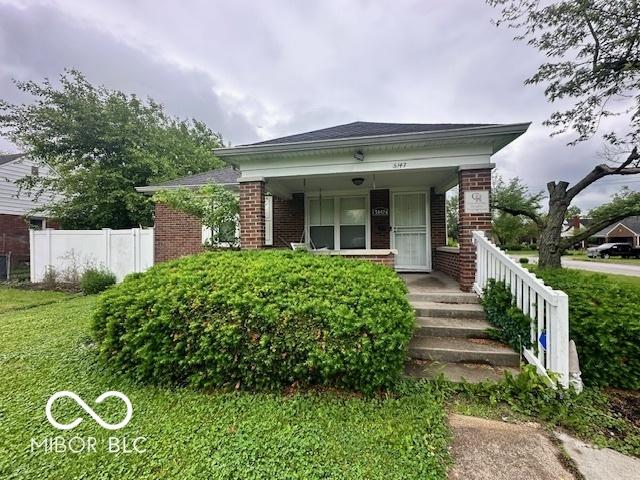 5147 E 16th St, Indianapolis, IN 46218 - view of front of property with brick siding and covered porch