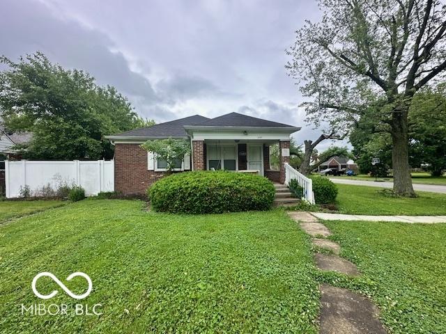 5147 E 16th St, Indianapolis, IN 46218 - bungalow with brick siding and covered porch