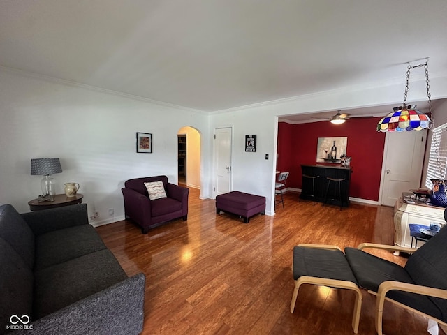 5147 E 16th St, Indianapolis, IN 46218 - living room with arched walkways, wood finished floors, crown molding, ceiling fan, and baseboards