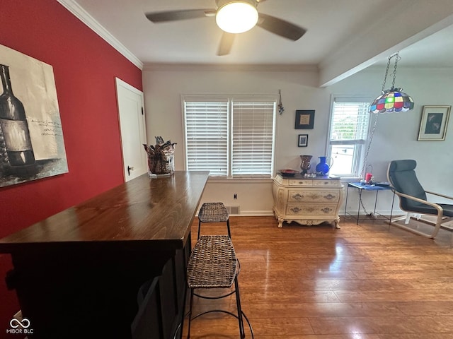 5147 E 16th St, Indianapolis, IN 46218 - dining room featuring ceiling fan, wood finished floors, ornamental molding, and baseboards