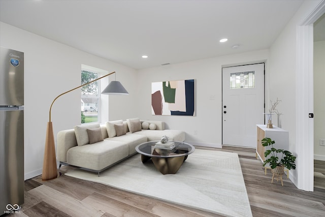 2631 Collier St, Indianapolis, IN 46241 - living area with healthy amount of natural light, recessed lighting, wood finished floors, and baseboards